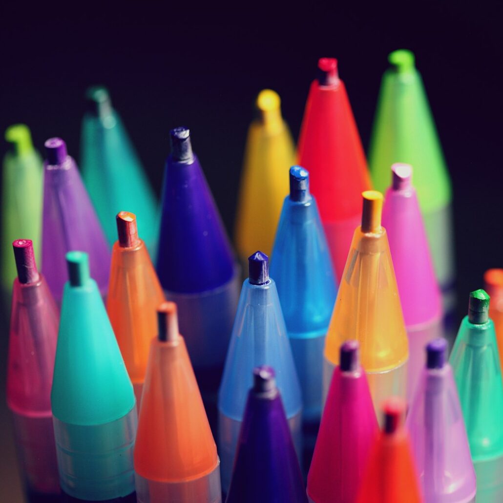 multi colored pen lot on black background